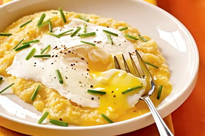 Eggs blindfolded over garlic-cheddar grits recipe-CookingEggs